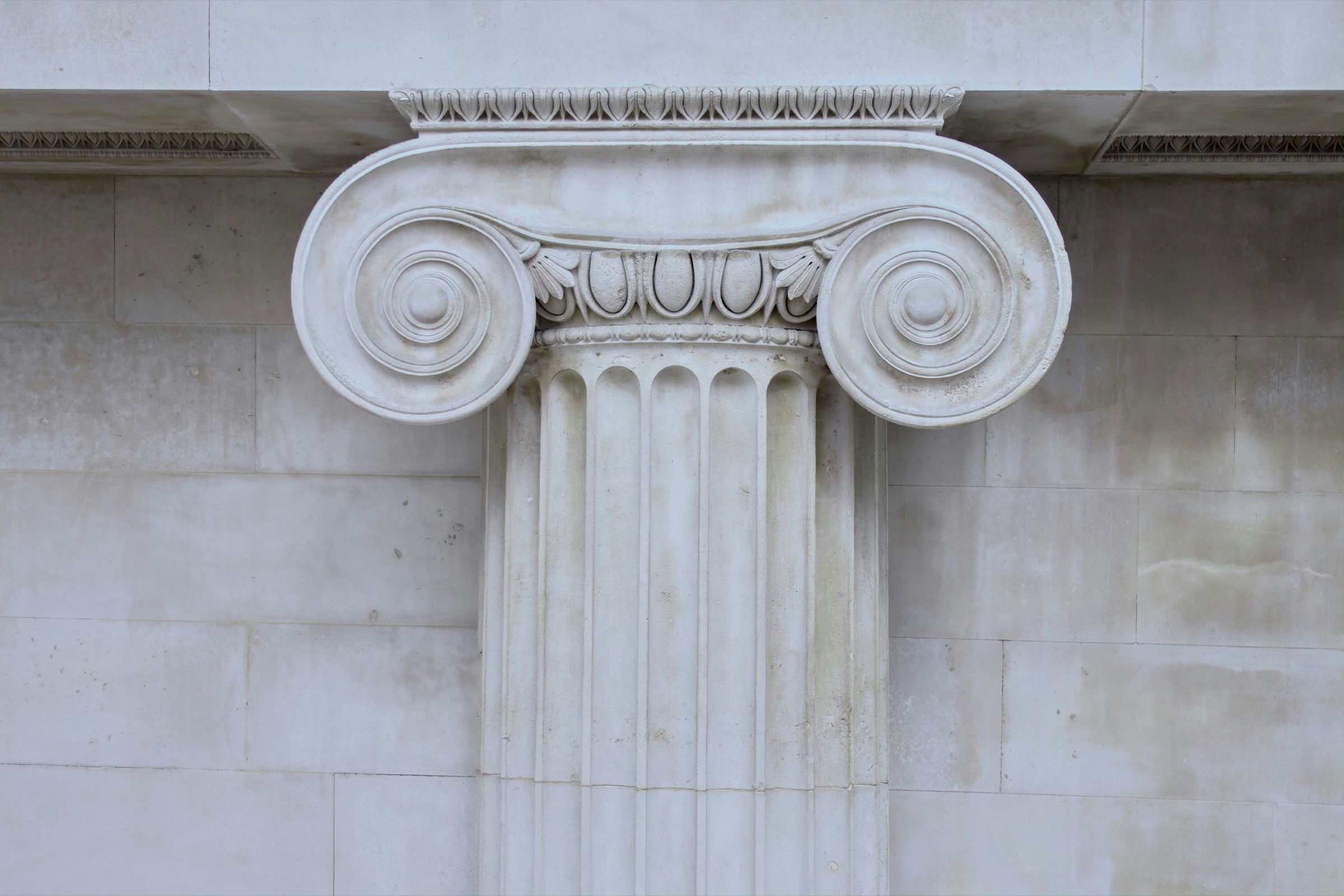 An Ionic column capital in white stone