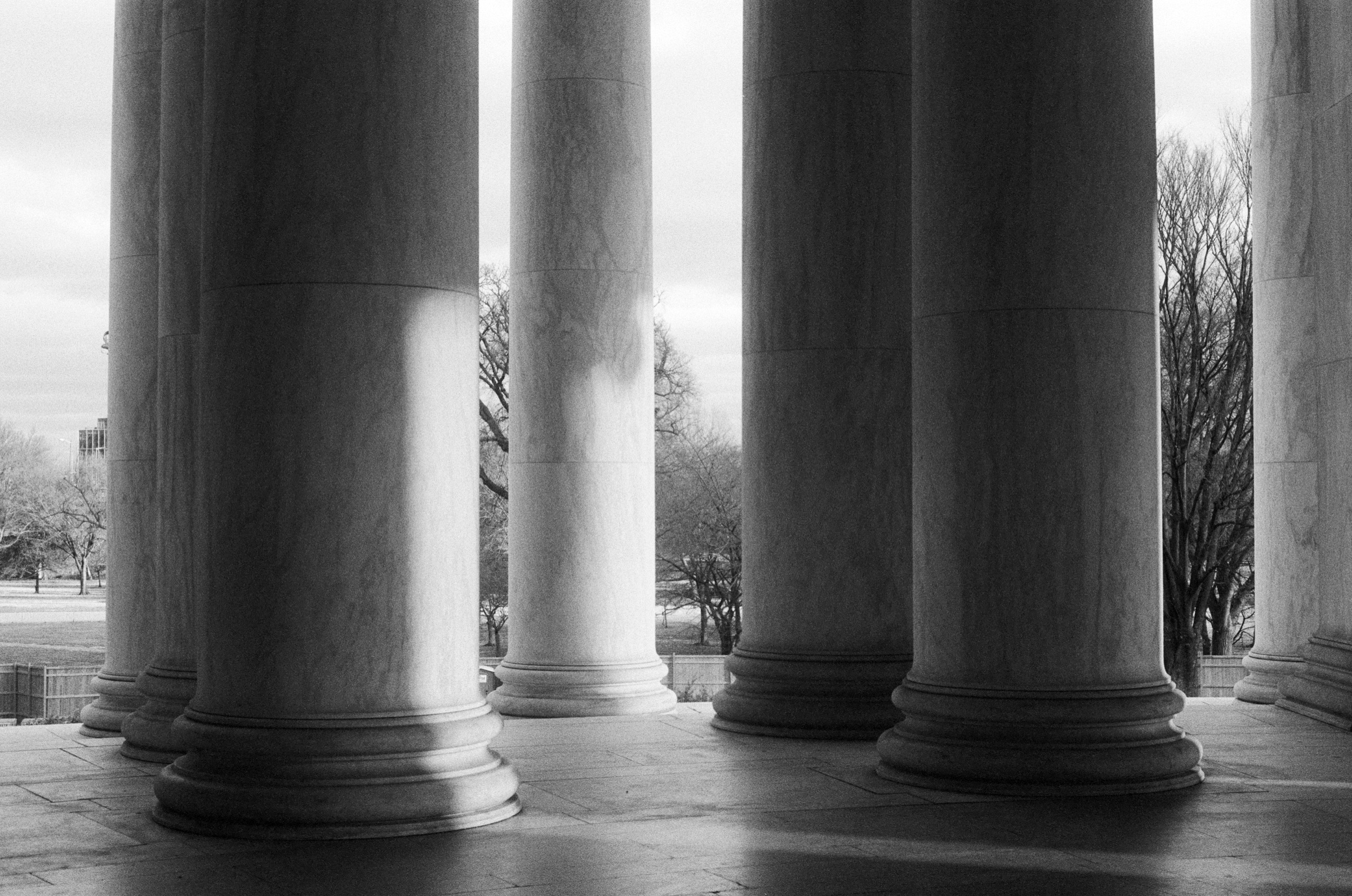 Marble columns in sunlight and shadow, black and white